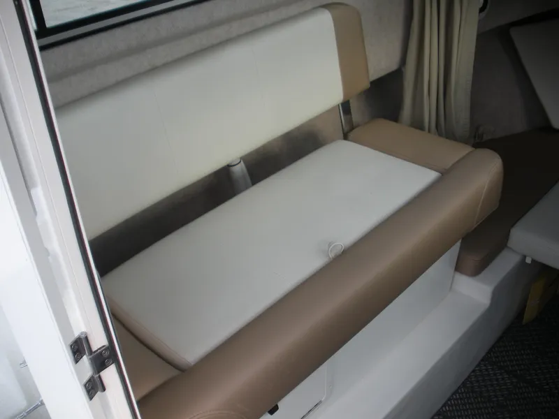 Slide: The Image of 2018 Parker 2120 Sport Cabin interior seating with beige and white upholstery. - 10