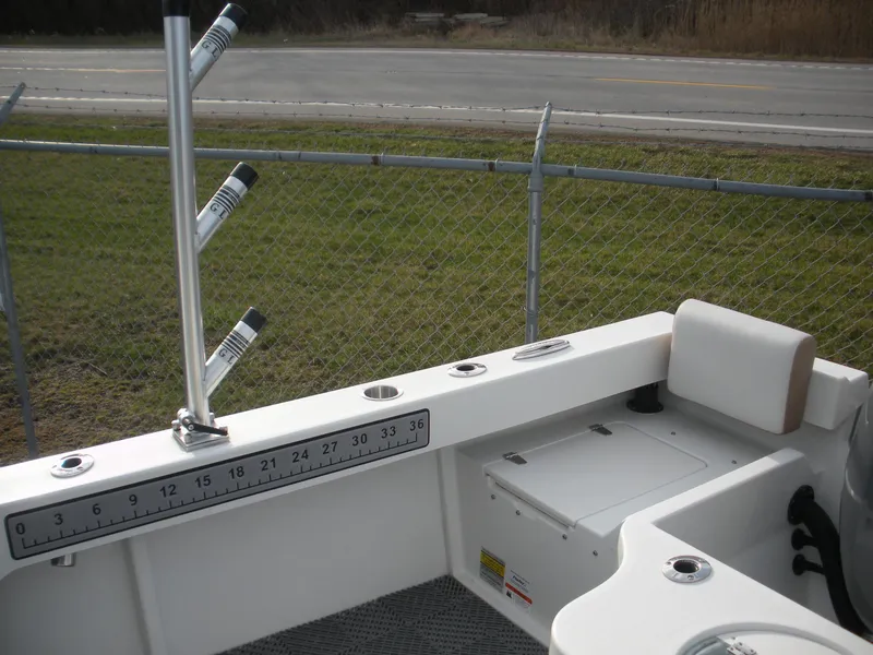 Slide: The Image of 2018 Parker 2120 Sport Cabin boat interior with rod holders and measurement guide. - 12