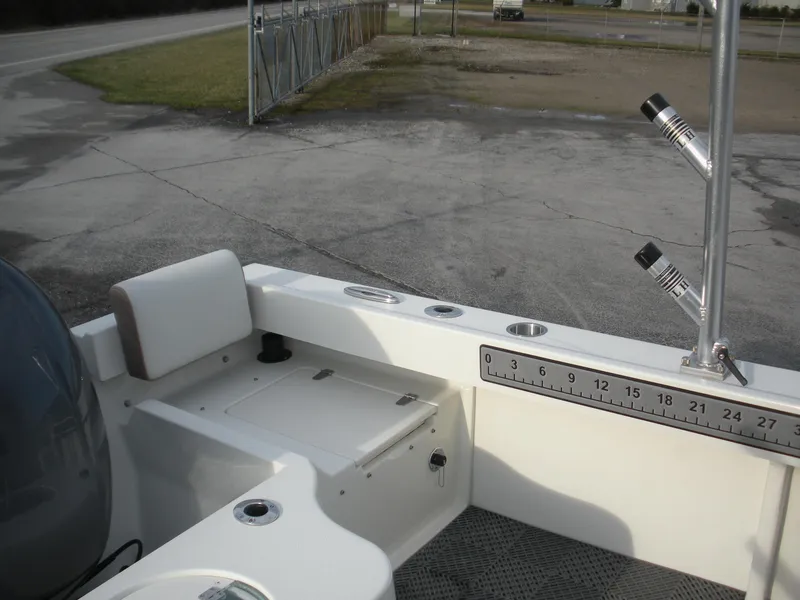 Slide: The Image of 2018 Parker 2120 Sport Cabin boat interior with rod holders and measuring ruler. - 13