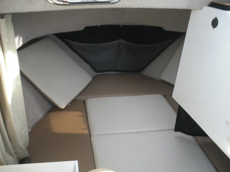 Slide: The Image of 2018 Parker 2120 Sport Cabin interior with cushioned seating and storage compartments. - 5