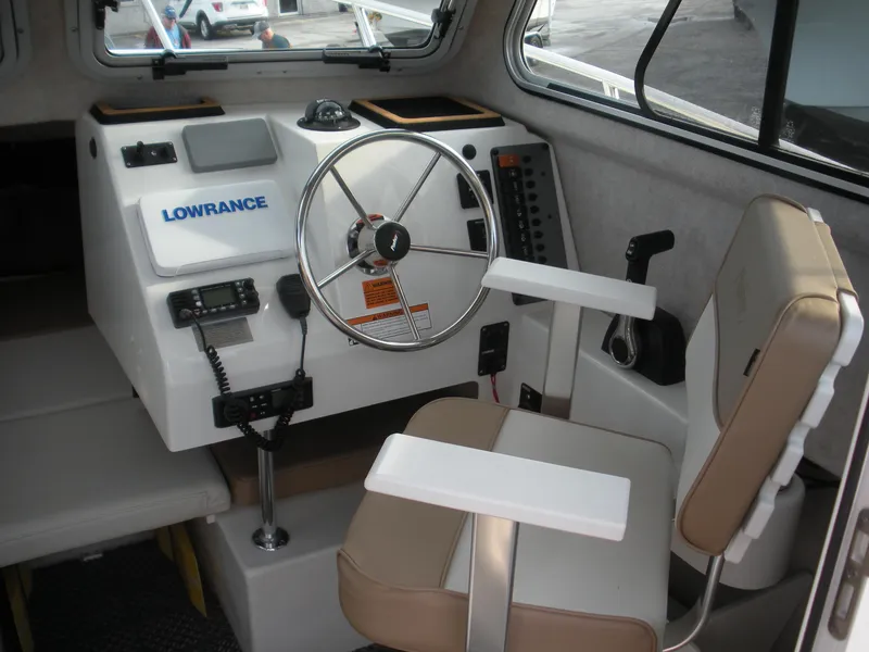 Slide: The Image of 2018 Parker 2120 Sport Cabin interior with steering wheel and navigation equipment. - 7