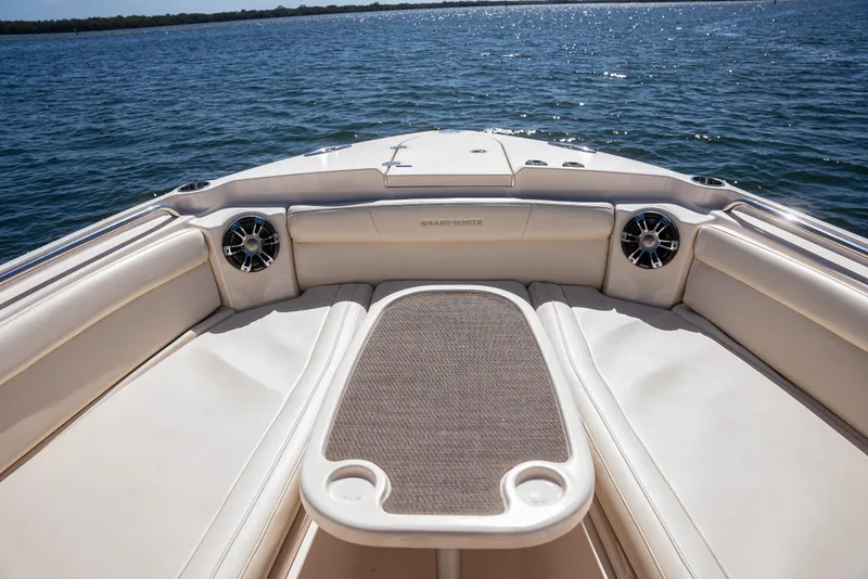 Slide: The Image of 2020 Grady-White Freedom 285 boat interior with seating and table on open water. - 10