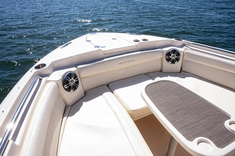 Slide: The Image of 2020 Grady-White Freedom 285 boat interior with seating and table on water. - 11