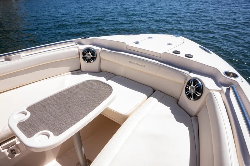 Slide: The Image of 2020 Grady-White Freedom 285 boat interior with seating and table on calm water. - 12