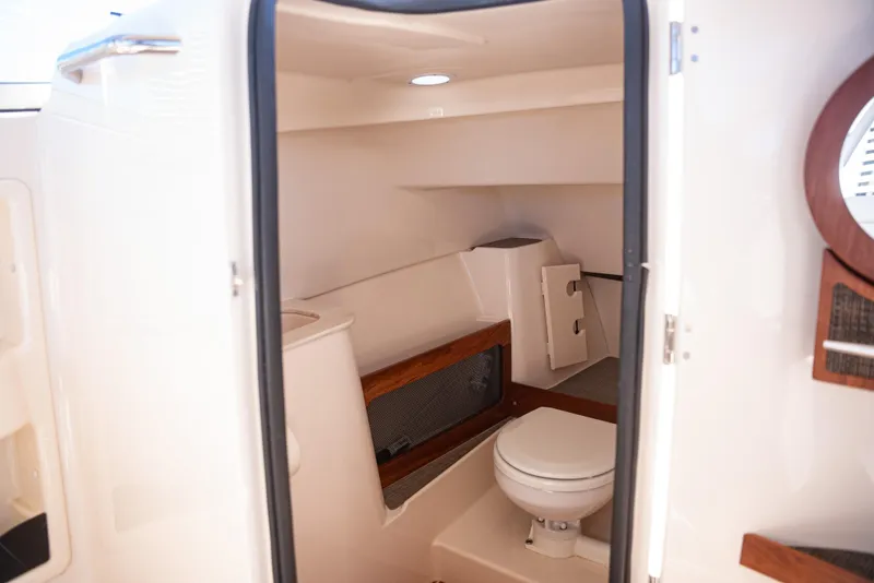 Slide: The Image of 2020 Grady-White Freedom 285 boat interior with compact bathroom amenities. - 14