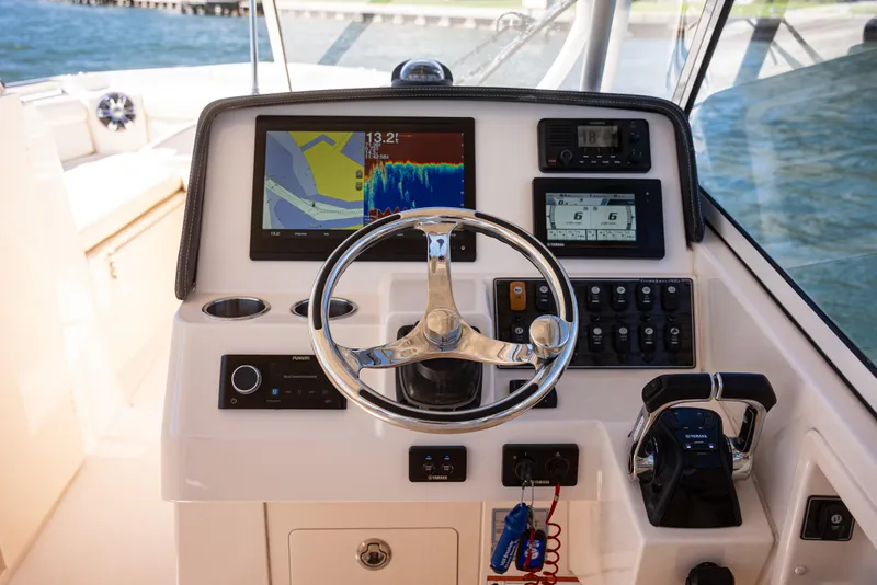 Slide: The Image of 2020 Grady-White Freedom 285 boat dashboard with navigation and control systems. - 19