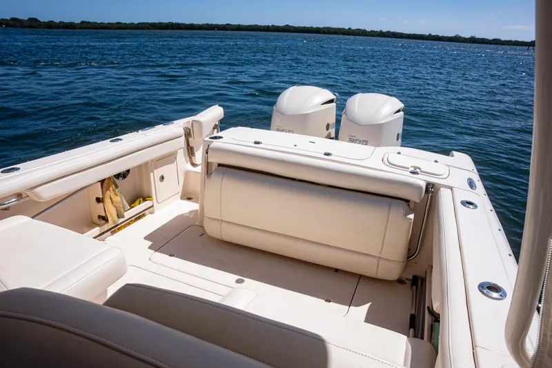 Slide: The Image of 2020 Grady-White Freedom 285 boat interior with twin engines on a sunny day. - 23