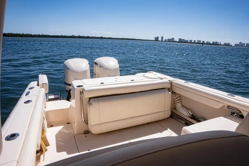 Slide: The Image of 2020 Grady-White Freedom 285 boat on open water, featuring dual engines and spacious seating. - 24