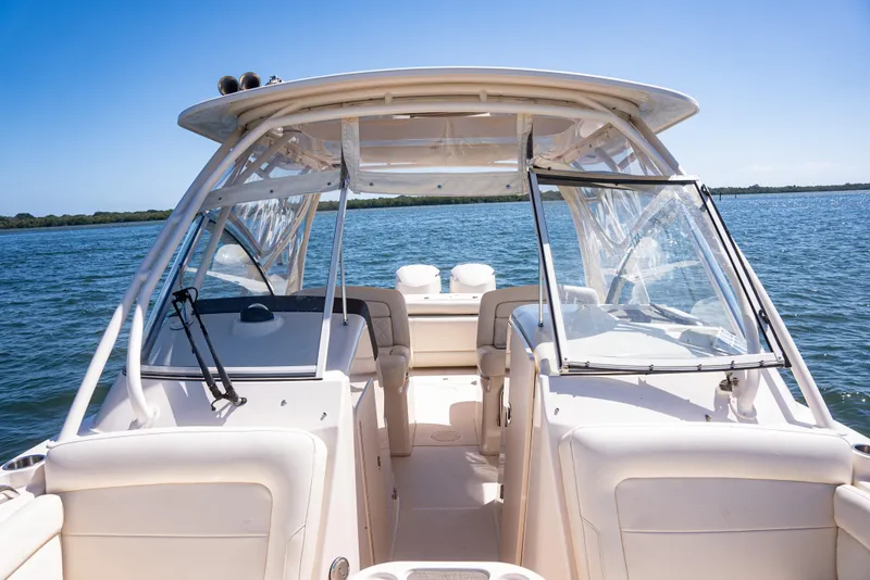 Slide: The Image of 2020 Grady-White Freedom 285 boat on open water, showcasing cockpit and seating area. - 27