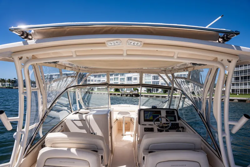 Slide: The Image of 2020 Grady-White Freedom 285 boat interior with helm, seats, and waterfront view. - 28