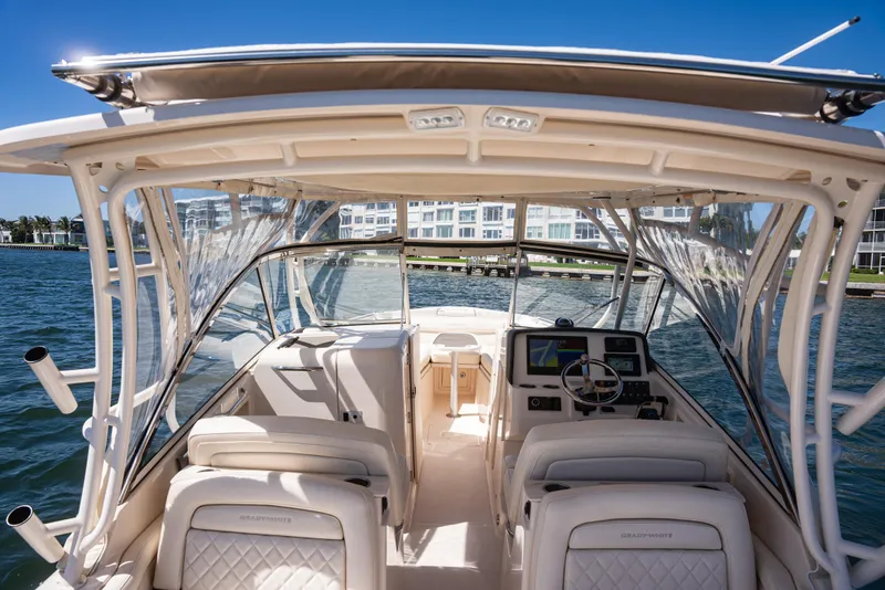 Slide: The Image of 2020 Grady-White Freedom 285 boat interior with helm, seats, and waterfront view. - 29