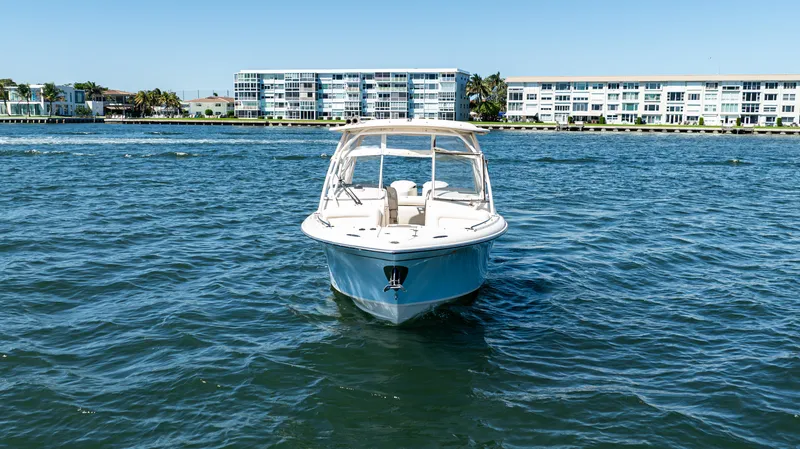 Slide: The Image of 2020 Grady-White Freedom 285 boat on water with coastal buildings in background. - 4