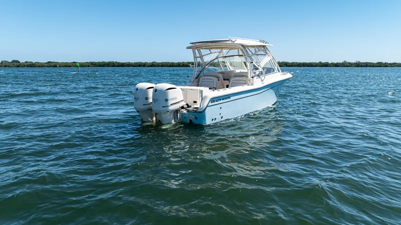 Slide: The Image of 2020 Grady-White Freedom 285 boat on open water under clear blue sky. - 5