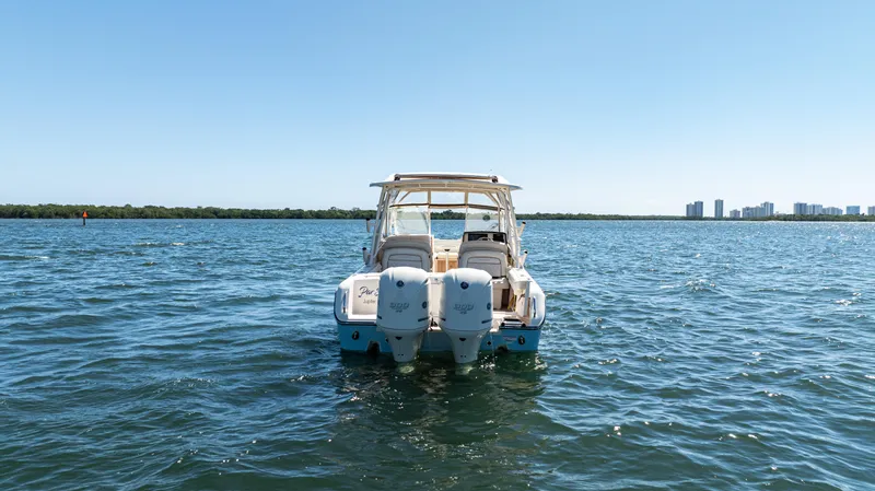Slide: The Image of 2020 Grady-White Freedom 285 boat on open water with city skyline in background. - 7