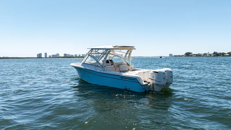 Slide: The Image of 2020 Grady-White Freedom 285 boat on open water, clear sky background. - 8