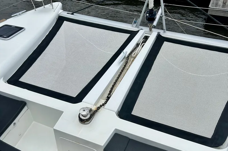 Slide: The Image of 2019 Lagoon 450 F Owner's Edition catamaran with netted deck area. - 14