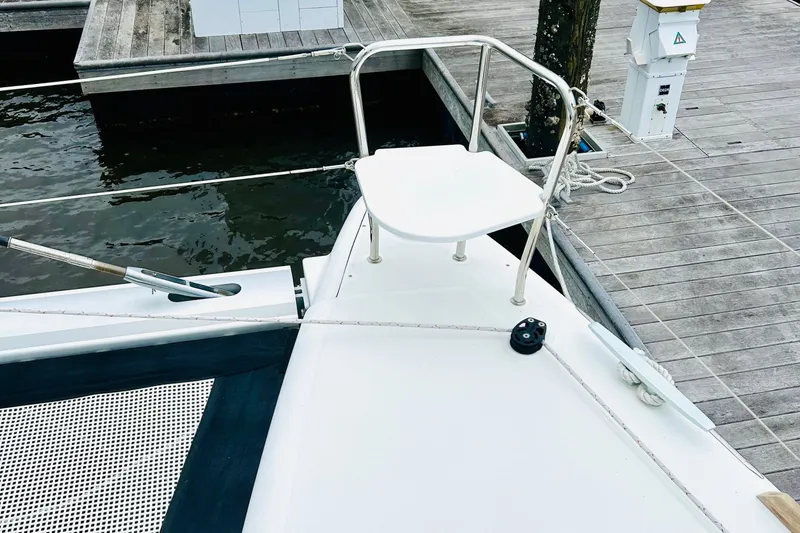 Slide: The Image of 2019 Lagoon 450 F Owner's Edition yacht at dock, featuring a sleek bow design. - 15