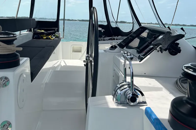 Slide: The Image of Helm station of 2019 Lagoon 450 F Owner's Edition catamaran with ocean view. - 2