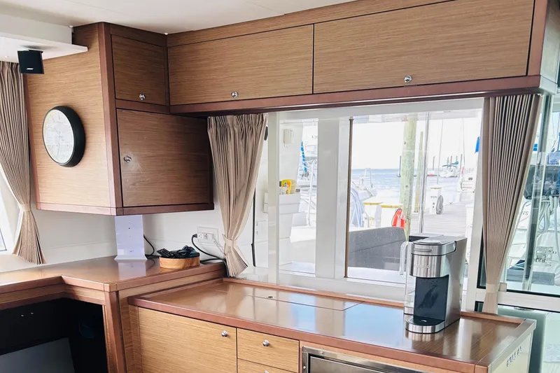 Slide: The Image of Interior of 2019 Lagoon 450 F Owner's Edition yacht with modern kitchen and ocean view. - 22
