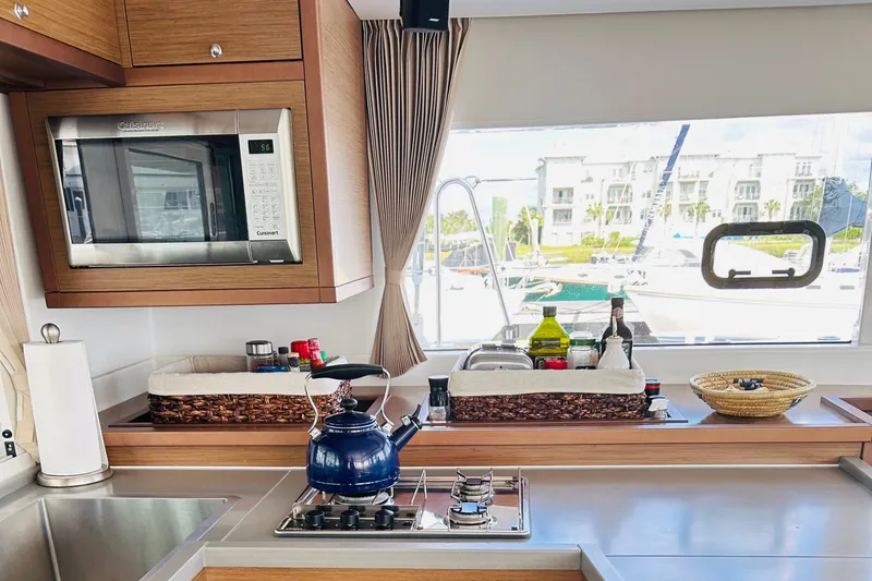 Slide: The Image of Modern kitchen in 2019 Lagoon 450 F yacht with stove, microwave, and window view. - 23