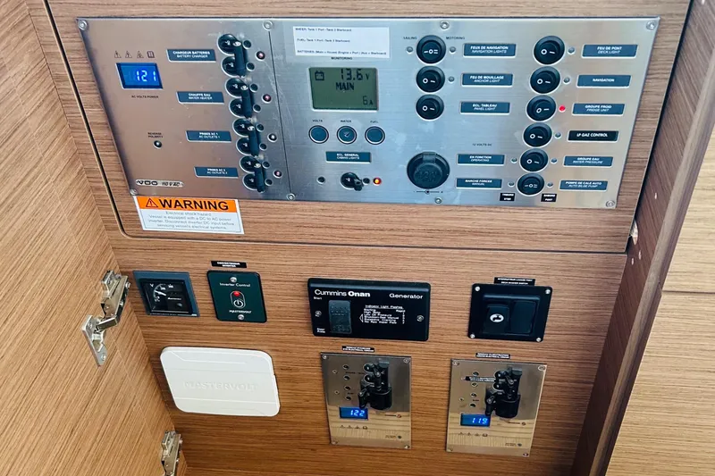Slide: The Image of Control panel of a 2019 Lagoon 450 F Owner's Edition yacht, featuring various switches and displays. - 27