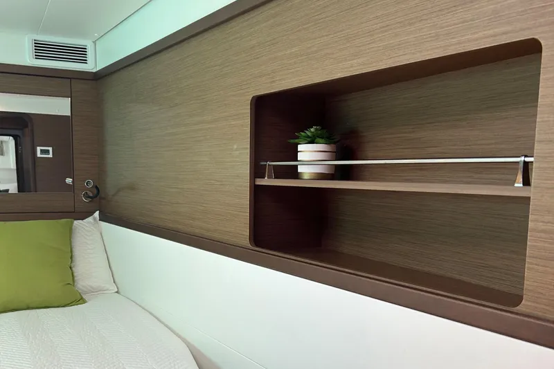 Slide: The Image of Interior of 2019 Lagoon 450 F yacht with wooden shelving and green cushion. - 38