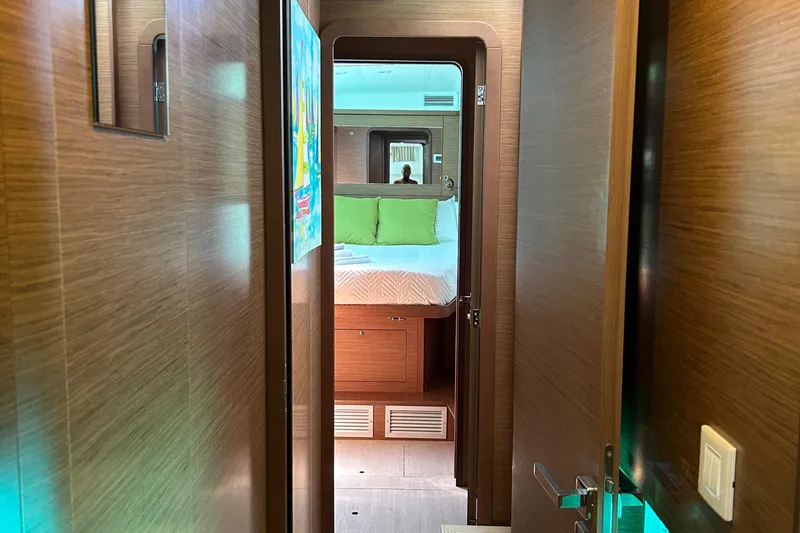 Slide: The Image of Interior view of 2019 Lagoon 450 F Owner's Edition yacht cabin with bed and wooden finish. - 39