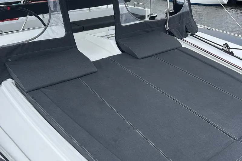Slide: The Image of Sunbathing area on 2019 Lagoon 450 F Owner's Edition catamaran, featuring comfortable cushions. - 4