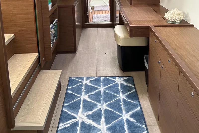 Slide: The Image of Interior of 2019 Lagoon 450 F Owner's Edition yacht with modern wood finish and blue rug. - 43