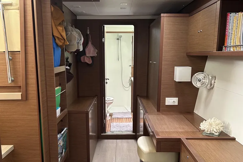Slide: The Image of Interior of 2019 Lagoon 450 F Owner's Edition yacht, featuring wood cabinetry and compact workspace. - 44