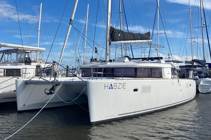 Slide: The Image of 2019 Lagoon 450 F Owner's Edition catamaran docked in marina. - 45