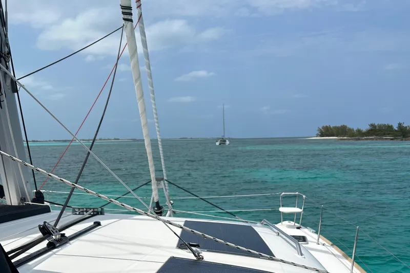 Slide: The Image of Sailing on a 2019 Lagoon 450 F Owner's Edition in clear turquoise waters. - 7