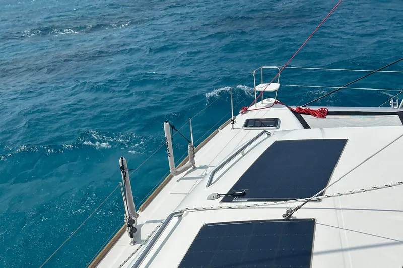Slide: The Image of 2019 Lagoon 450 F Owner's Edition sailing on clear blue ocean waters. - 8