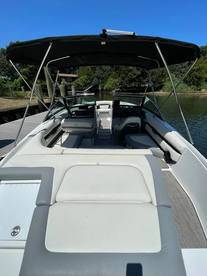 Slide: The Image of 2018 Cobalt CS22 boat with canopy, docked on a sunny day. - 8