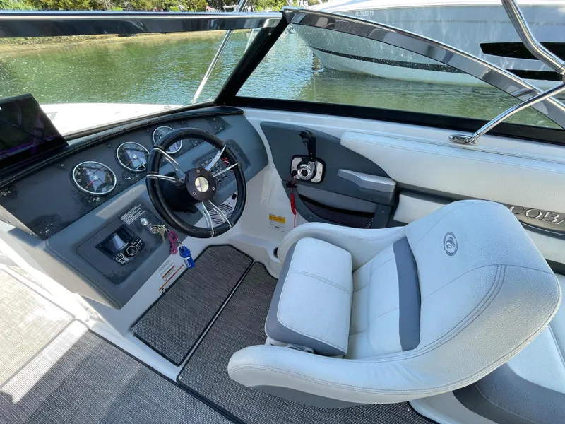Slide: The Image of Interior of a 2018 Cobalt CS22 boat showing steering wheel and dashboard controls. - 9
