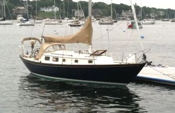 The Image of 1972 Bristol 40 sailboat docked in a marina, surrounded by other boats. - 0