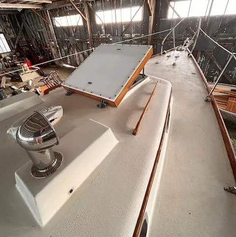 Slide: The Image of 1972 Bristol 40 sailboat deck in a rustic indoor setting. - 11
