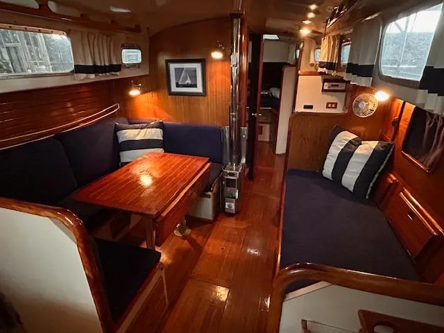 Slide: The Image of 1972 Bristol 40 yacht interior with wooden furnishings and navy blue seating. - 14