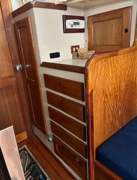 Slide: The Image of 1972 Bristol 40 interior with wooden cabinetry and blue cushioned seating. - 19