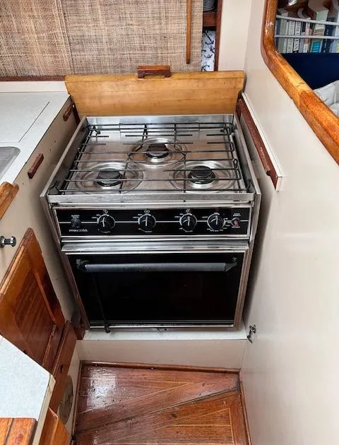 Slide: The Image of 1972 Bristol 40 yacht kitchen with a stainless steel stove and oven. - 25
