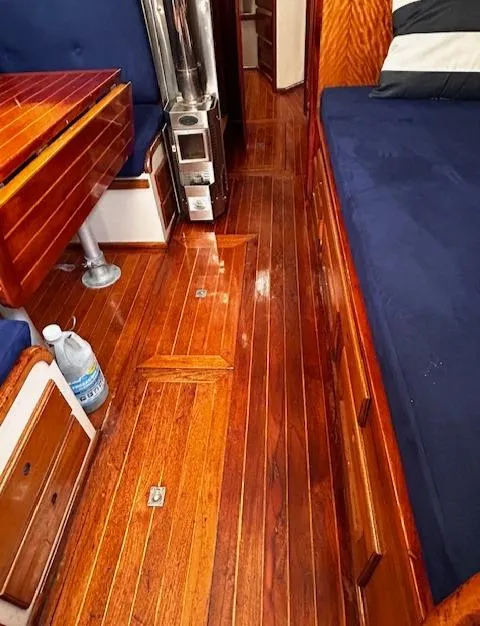 Slide: The Image of 1972 Bristol 40 yacht interior with polished wood flooring and blue upholstery. - 26
