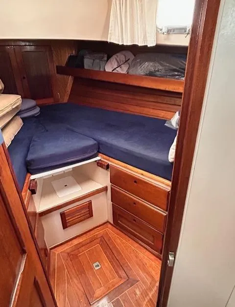 Slide: The Image of 1972 Bristol 40 yacht cabin with wooden interior and blue cushions. - 27