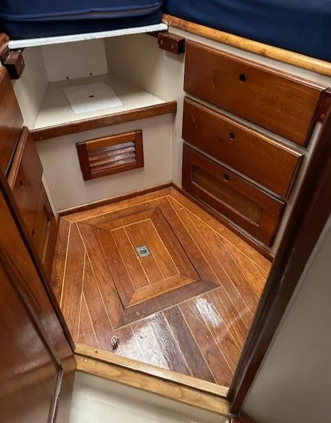 Slide: The Image of 1972 Bristol 40 sailboat interior with wooden cabinetry and flooring. - 28