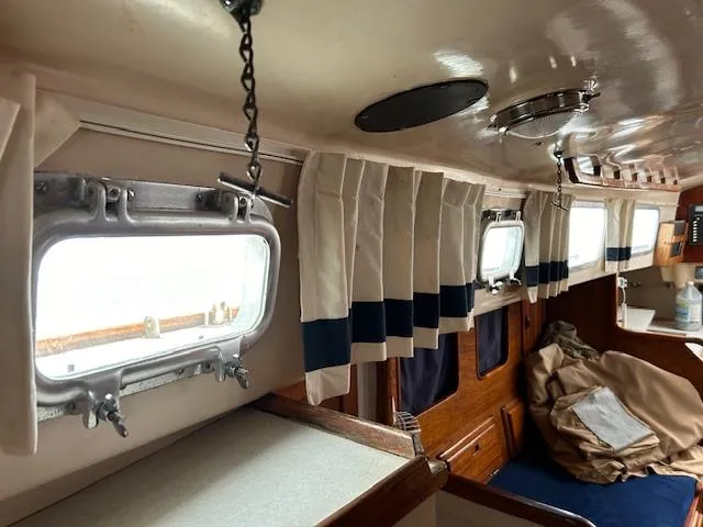 Slide: The Image of Interior of a 1972 Bristol 40 sailboat with portholes and curtains. - 34