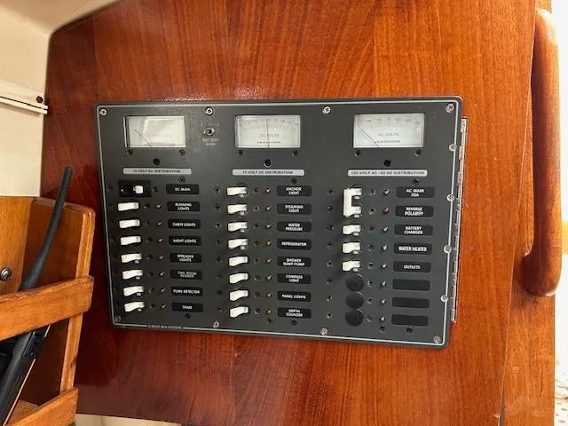 Slide: The Image of Electrical control panel on a 1972 Bristol 40 sailboat, featuring switches and meters. - 38