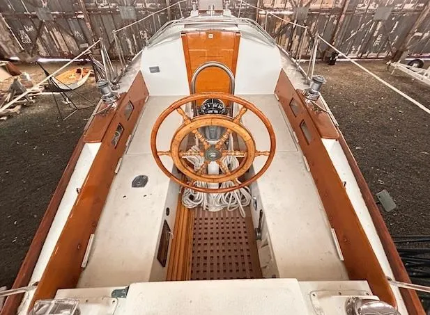 Slide: The Image of 1972 Bristol 40 sailboat cockpit with wooden wheel and classic design elements. - 8