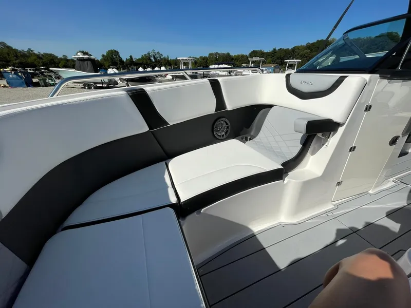 Slide: The Image of 2025 Chaparral 270 OSX boat interior with sleek white and black seating. - 14