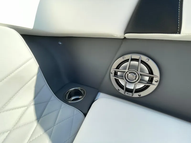 Slide: The Image of 2025 Chaparral 270 OSX boat interior with speaker and cup holder. - 21