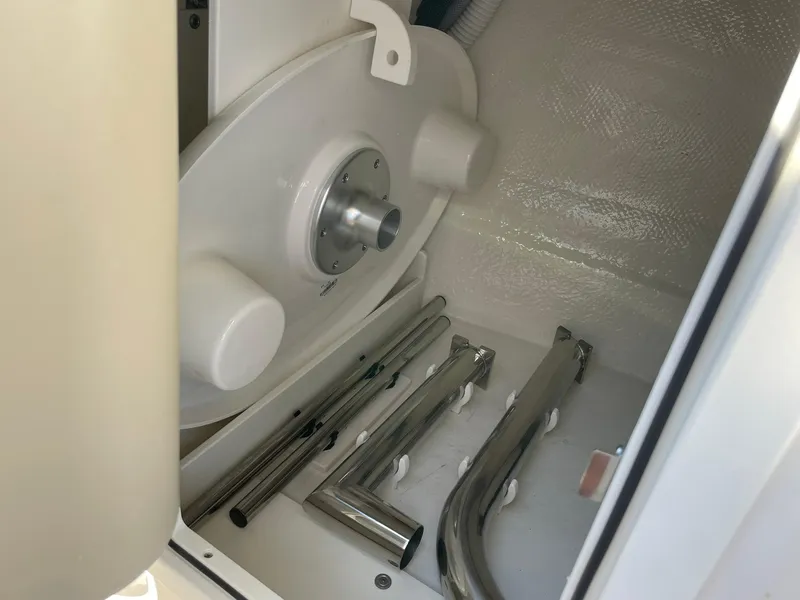 Slide: The Image of Storage compartment of 2025 Chaparral 270 OSX boat with metal components. - 28