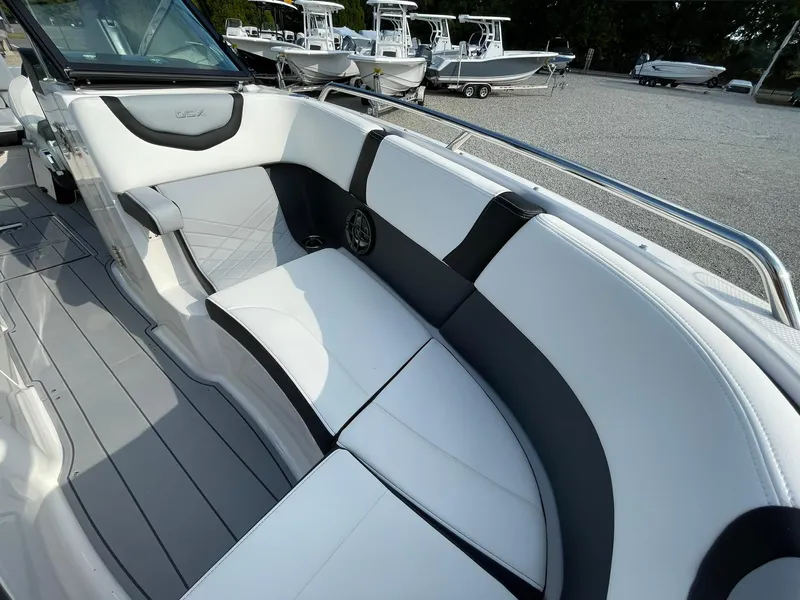 Slide: The Image of 2025 Chaparral 270 OSX boat interior with sleek white and gray seating. - 13